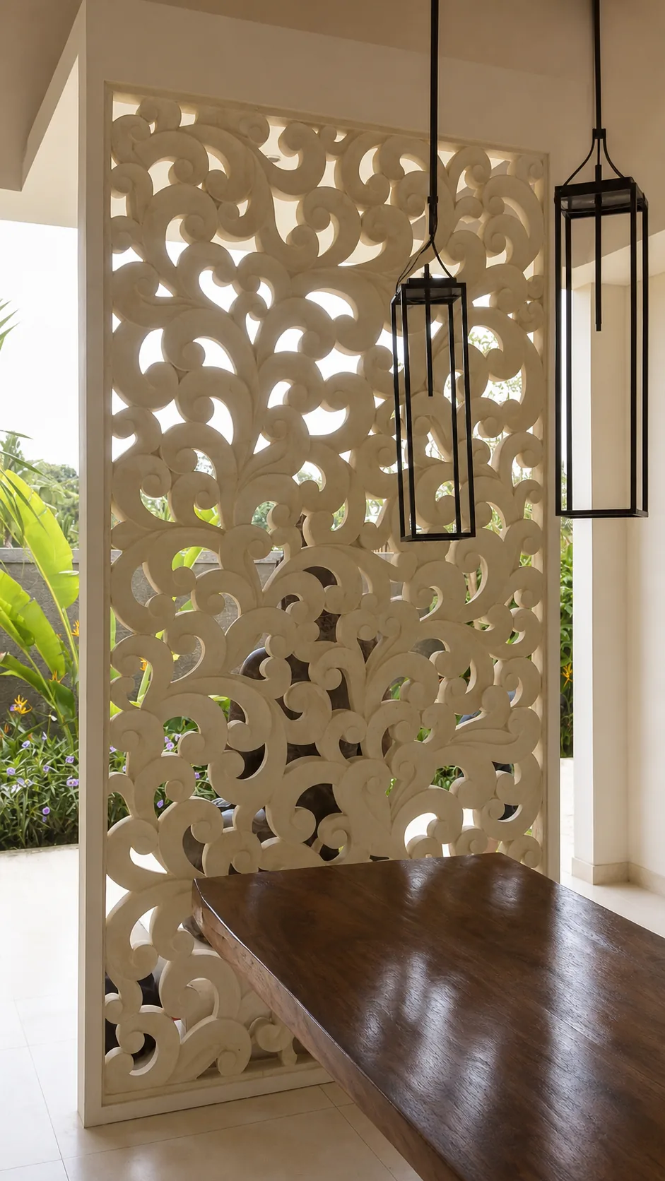 Perforated carved stone screen integrated into a tropical residence