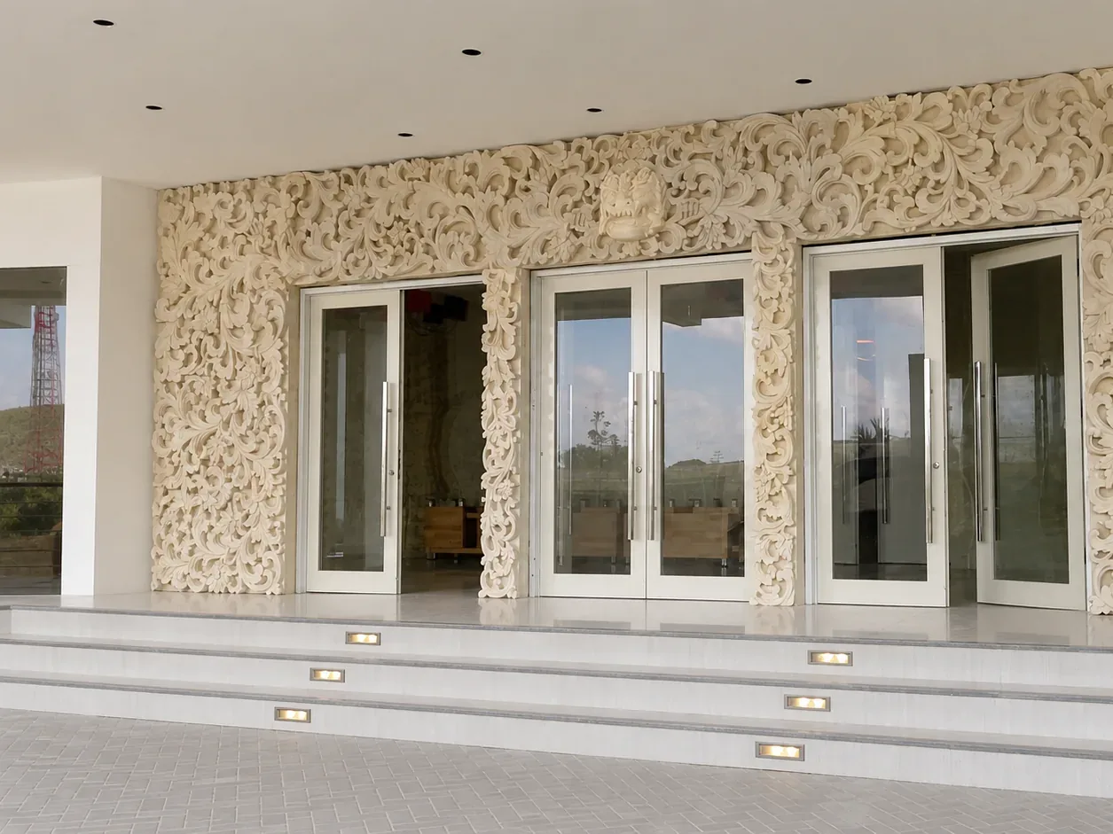 Close view of botanical carving around the entrance doors